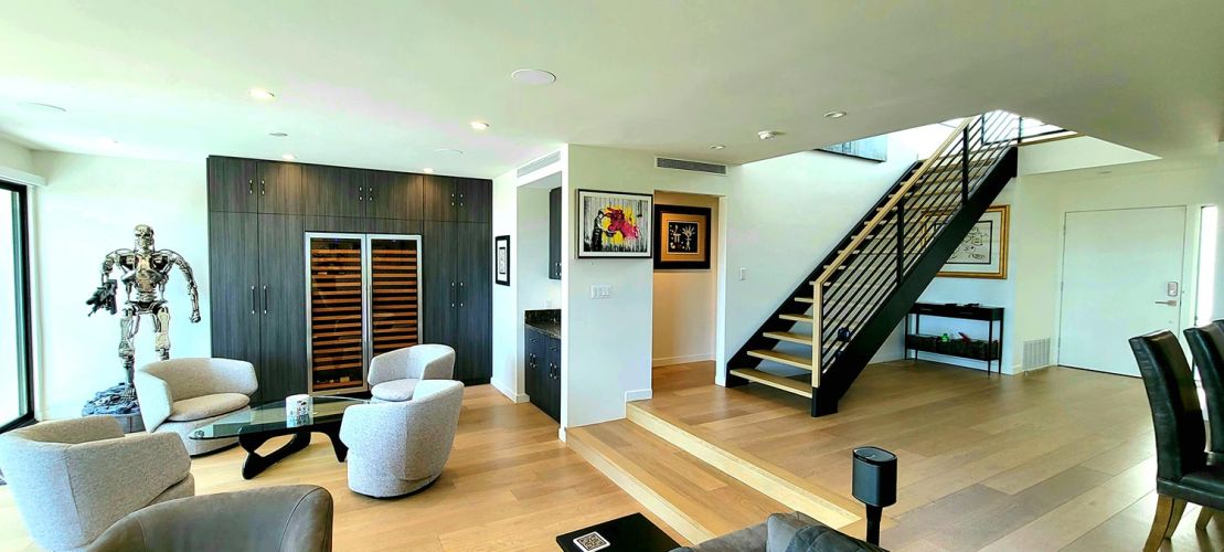 Modern living area with open staircase and large wine storage