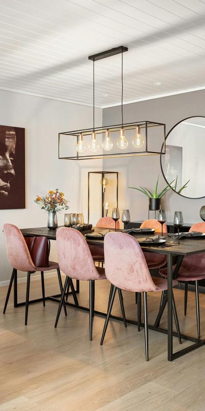 Dining room with pink chairs and a rectangular pendant light