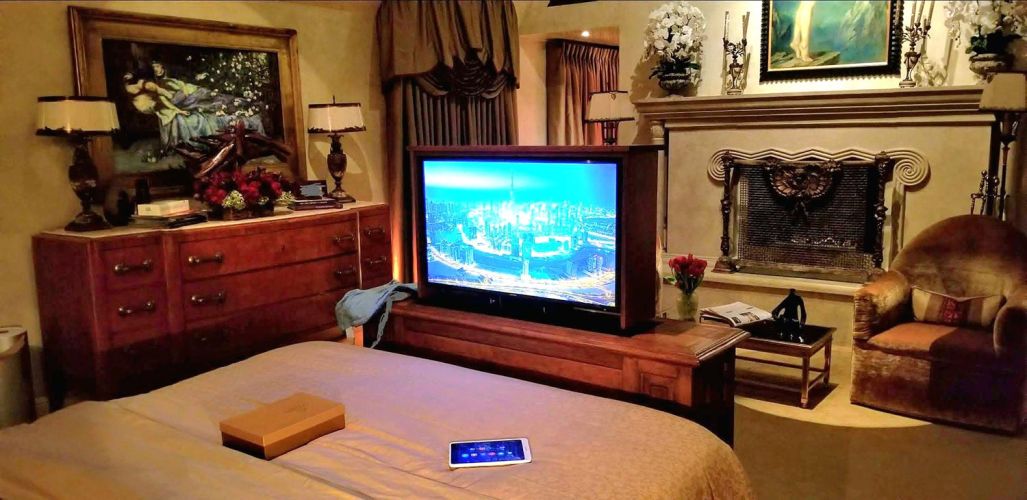 Bedroom with a hidden TV lift displaying a city skyline